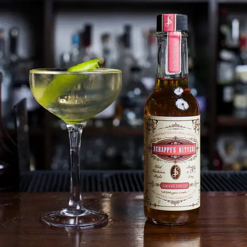 grapefruit-bitters-for-a-cocktail-in-a-coupe-glass-with-lime-garnish